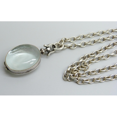 7174 - A rock crystal locket pendant on a long silver belcher chain, 45g, 4.5cm including bale, 75cm chain