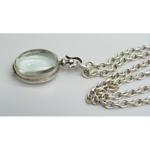 7174 - A rock crystal locket pendant on a long silver belcher chain, 45g, 4.5cm including bale, 75cm chain