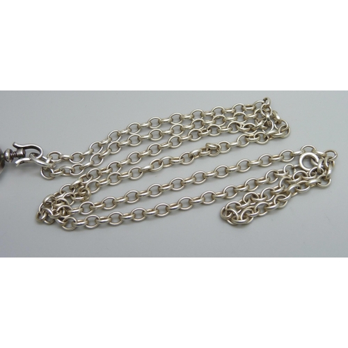 7174 - A rock crystal locket pendant on a long silver belcher chain, 45g, 4.5cm including bale, 75cm chain