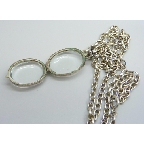 7174 - A rock crystal locket pendant on a long silver belcher chain, 45g, 4.5cm including bale, 75cm chain