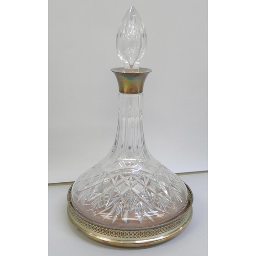 7269 - A silver mounted ship's decanter and a silver coaster, top of stopper chipped