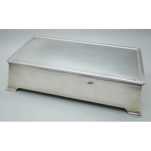 7271 - An Art Deco silver cigarette box, Birmingham 1929, inner case bears inscription, total weight 710g