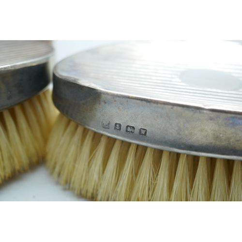 7281 - A pair of silver brushes in a fitted leather case, circa 1940s