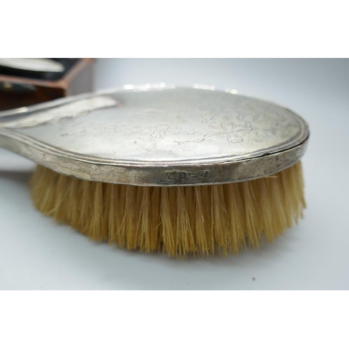 7287 - A 1940s silver backed brush, boxed and one other