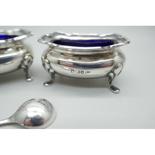 7292 - A pair of silver salts with blue glass liners and silver spoons, Walker & Hall, Sheffield 1908, 63g