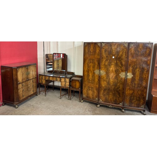 186 - A Queen Anne style figured walnut and parcel gilt bedroom suite, comprising; three door wardrobe, ta... 