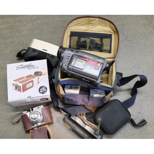 2162 - A Panasonic video recorder, smart phone projector, Koroll camera, VR set, reading light, hip flask