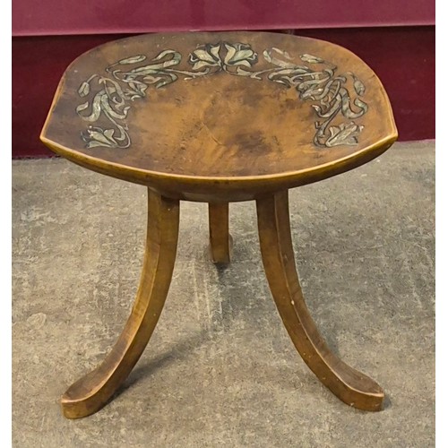 140A - An Arts and Crafts painted beech three legged Thebes stool, attributed to Liberty & Co.