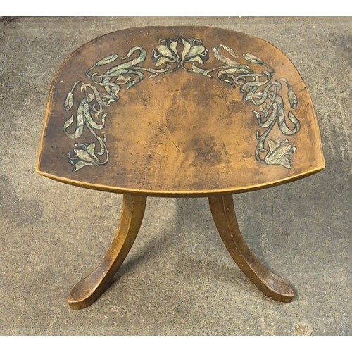 140A - An Arts and Crafts painted beech three legged Thebes stool, attributed to Liberty & Co.