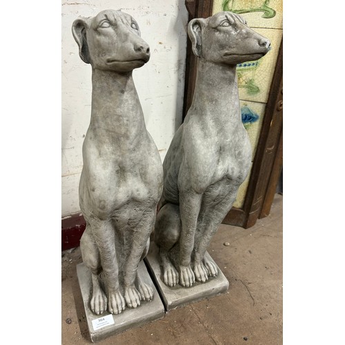 364 - A pair of concrete garden figures of seated greyhounds