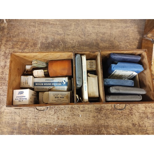 424 - A 1917 wooden first aid box, with paper instructions and contents