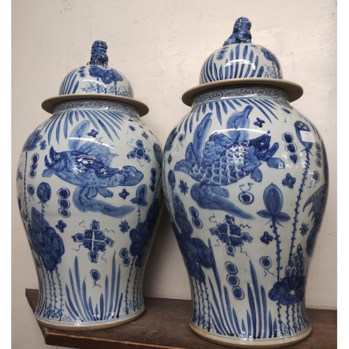 426 - A pair of large Chinese blue and white stoneware vases and covers