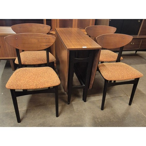 110 - A Nathan tola wood and black drop leaf table and four chairs