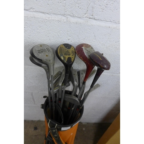 5165 - A vintage Penfold leather golf bag and a quantity of assorted vintage golf clubs including Impala, M... 