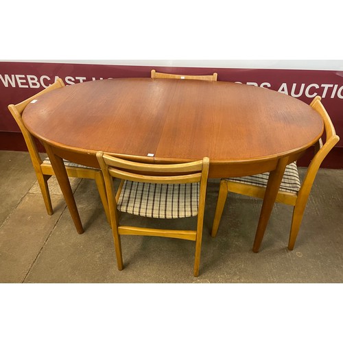 65 - A Jentique teak oval extending dining table and four chairs