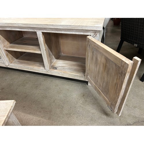 3026 - A wooden tv cabinet with a sandblast antique white finish