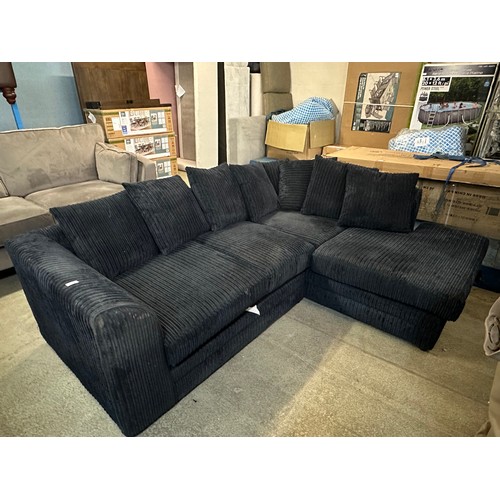 3233 - A black jumbo cord upholstered compact corner sofa - (transit marked)