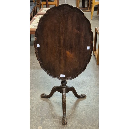 146A - An Edward VII Chippendale Revival carved mahogany tilt top tripod occasional table