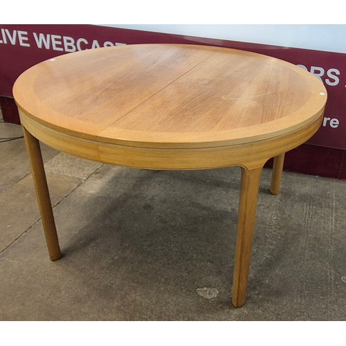 8 - A Nathan teak circular extending dining table