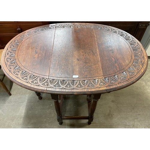 133 - An early 20th Century carved oak gateleg table