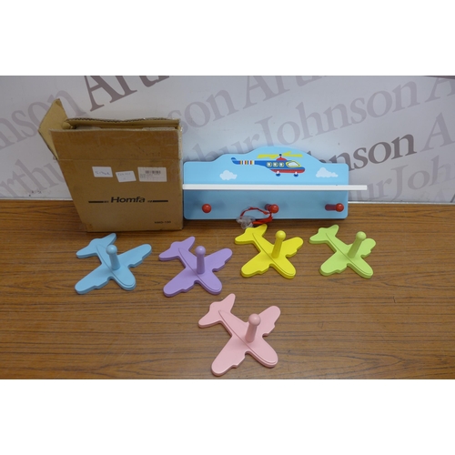 5243 - A quantity of childrens airplane coat hangers and a shelf with coat hangers