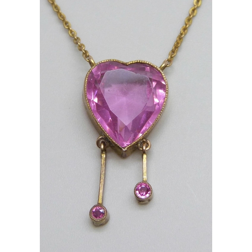 7001 - An Edwardian pink stone heart shaped drop pendant, rolled gold, 12mm wide