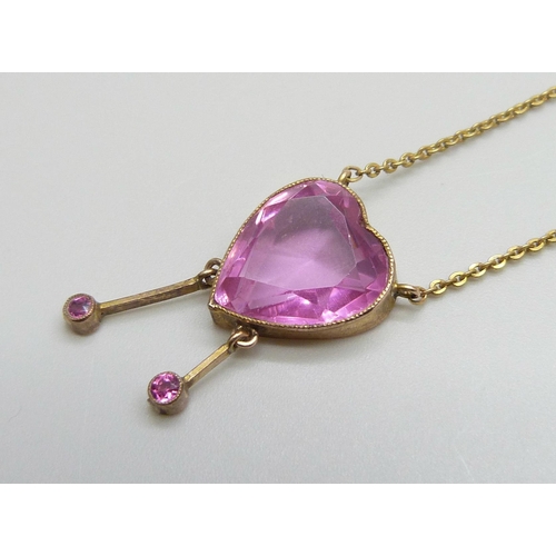 7001 - An Edwardian pink stone heart shaped drop pendant, rolled gold, 12mm wide