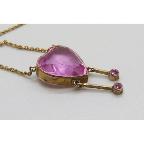 7001 - An Edwardian pink stone heart shaped drop pendant, rolled gold, 12mm wide