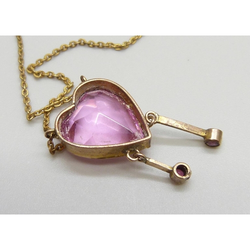 7001 - An Edwardian pink stone heart shaped drop pendant, rolled gold, 12mm wide