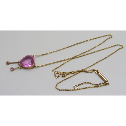 7001 - An Edwardian pink stone heart shaped drop pendant, rolled gold, 12mm wide