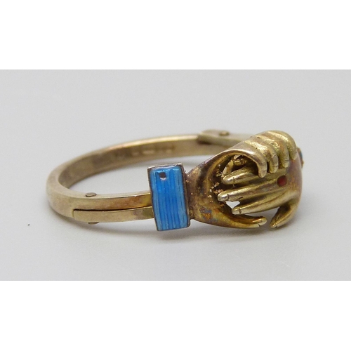 7005 - A 9ct gold and enamel clasped hands ring, opens to reveal an enamel heart, 3.6g, L/M