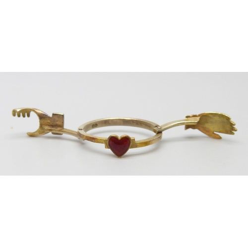 7005 - A 9ct gold and enamel clasped hands ring, opens to reveal an enamel heart, 3.6g, L/M