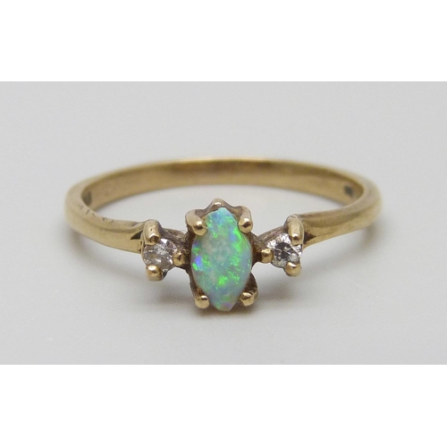 7006 - A 9ct gold ring set with an opal and two diamonds, 1.6g, N, small chips to the opal