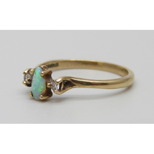 7006 - A 9ct gold ring set with an opal and two diamonds, 1.6g, N, small chips to the opal