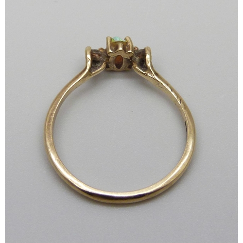 7006 - A 9ct gold ring set with an opal and two diamonds, 1.6g, N, small chips to the opal