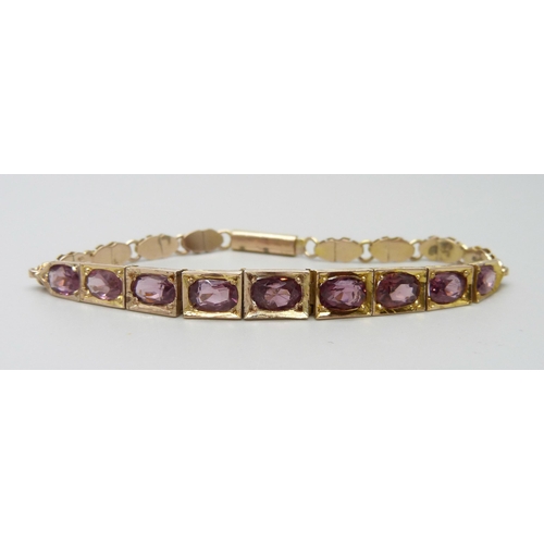 7012 - A 9ct gold and amethyst set bracelet, 10.9g, 17cm