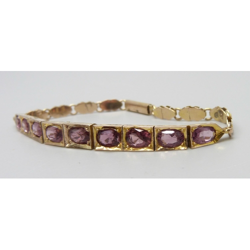 7012 - A 9ct gold and amethyst set bracelet, 10.9g, 17cm