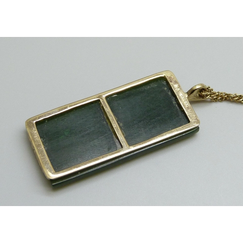 7033 - A 9ct gold mounted Chinese carved jade pendant on a 9ct gold chain, total weight 13.6g, chain 3.3g a... 