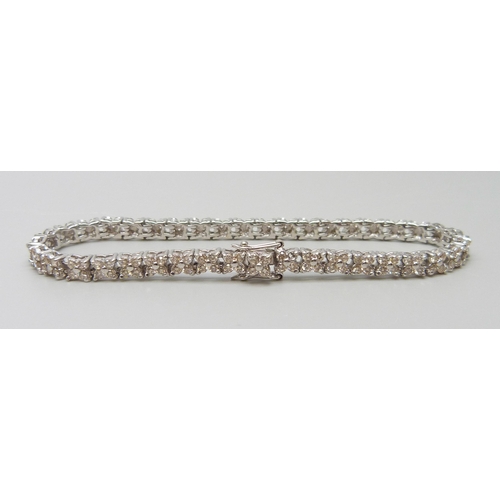 7035 - An 18ct white gold and diamond set tennis bracelet, lacking one diamond, 13.7g, 17cm