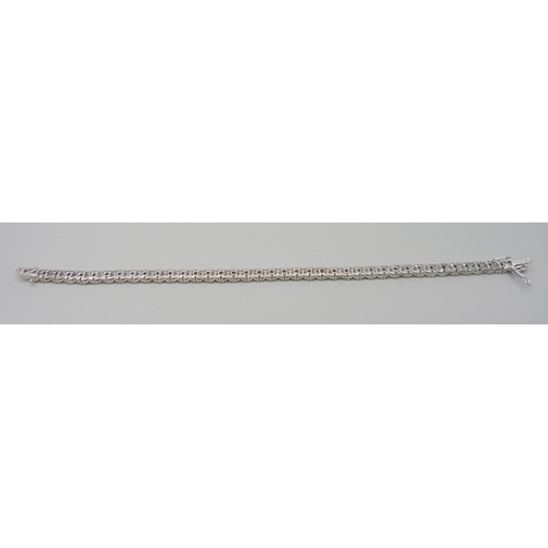 7035 - An 18ct white gold and diamond set tennis bracelet, lacking one diamond, 13.7g, 17cm