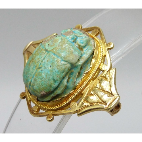 7036 - A yellow metal scarab beetle brooch, high carat, a/f, pin requires repair, 8.1g, 32mm wide