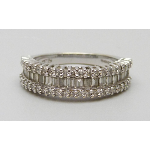 7038 - An 18ct white gold and diamond ring set with baguette and round cut diamonds, 4.4g, L