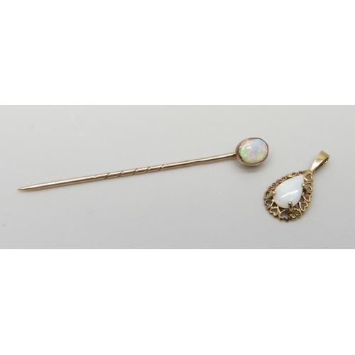 7048 - A 9ct gold stick pin set with an opal and a 9ct gold fretwork pendant with heart design border set w... 