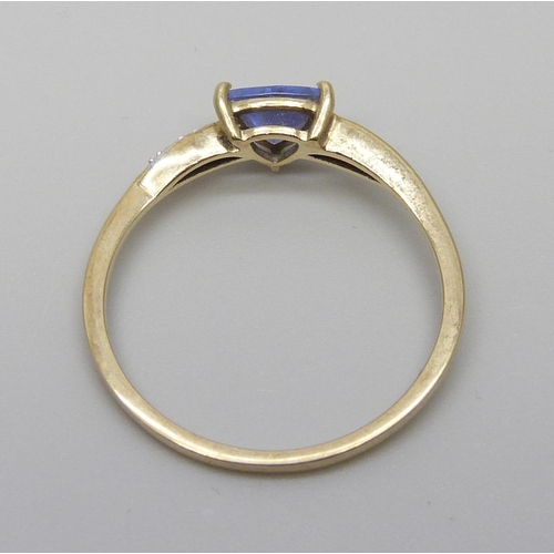 7057 - A 10k gold and tanzanite ring with diamond accents, 1.6g, U