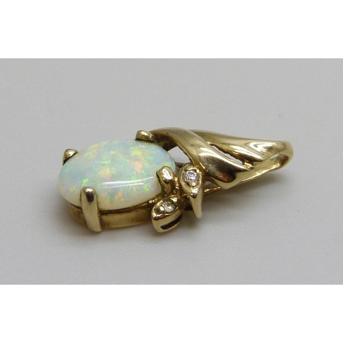 7063 - A 9ct gold pendant set with an opal and small diamonds, 1.1g, opal 7mm x 9mm