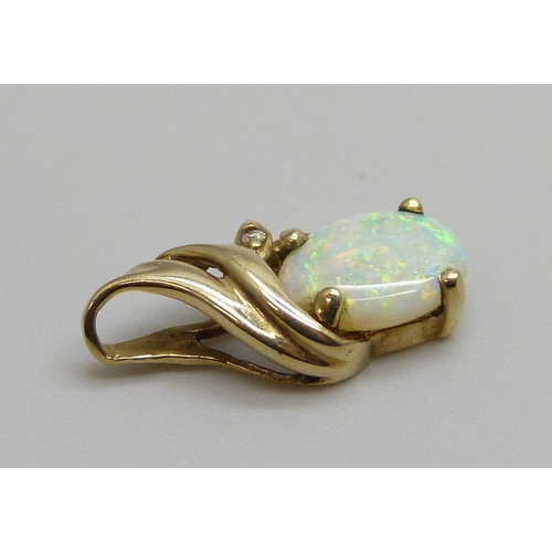 7063 - A 9ct gold pendant set with an opal and small diamonds, 1.1g, opal 7mm x 9mm