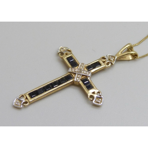 7088 - A 9ct gold cross pendant set with sapphires and diamonds, 3.5cm, on a 9ct gold chain, 1.7g