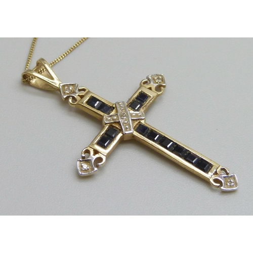 7088 - A 9ct gold cross pendant set with sapphires and diamonds, 3.5cm, on a 9ct gold chain, 1.7g