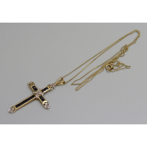 7088 - A 9ct gold cross pendant set with sapphires and diamonds, 3.5cm, on a 9ct gold chain, 1.7g