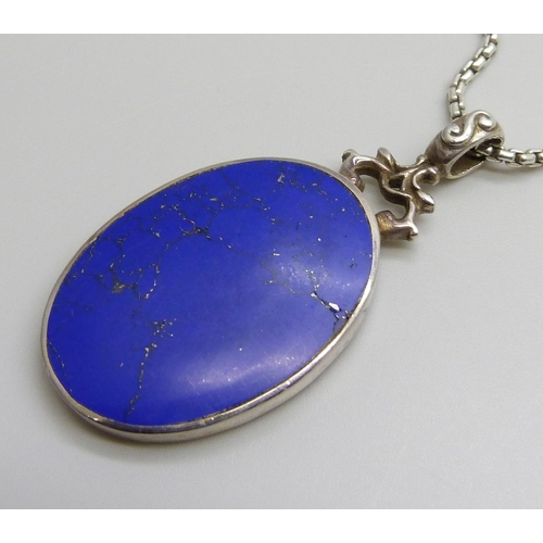 7108 - A silver pendant set with lapis lazuli, on a silver chain, 26g, pendant 5cm